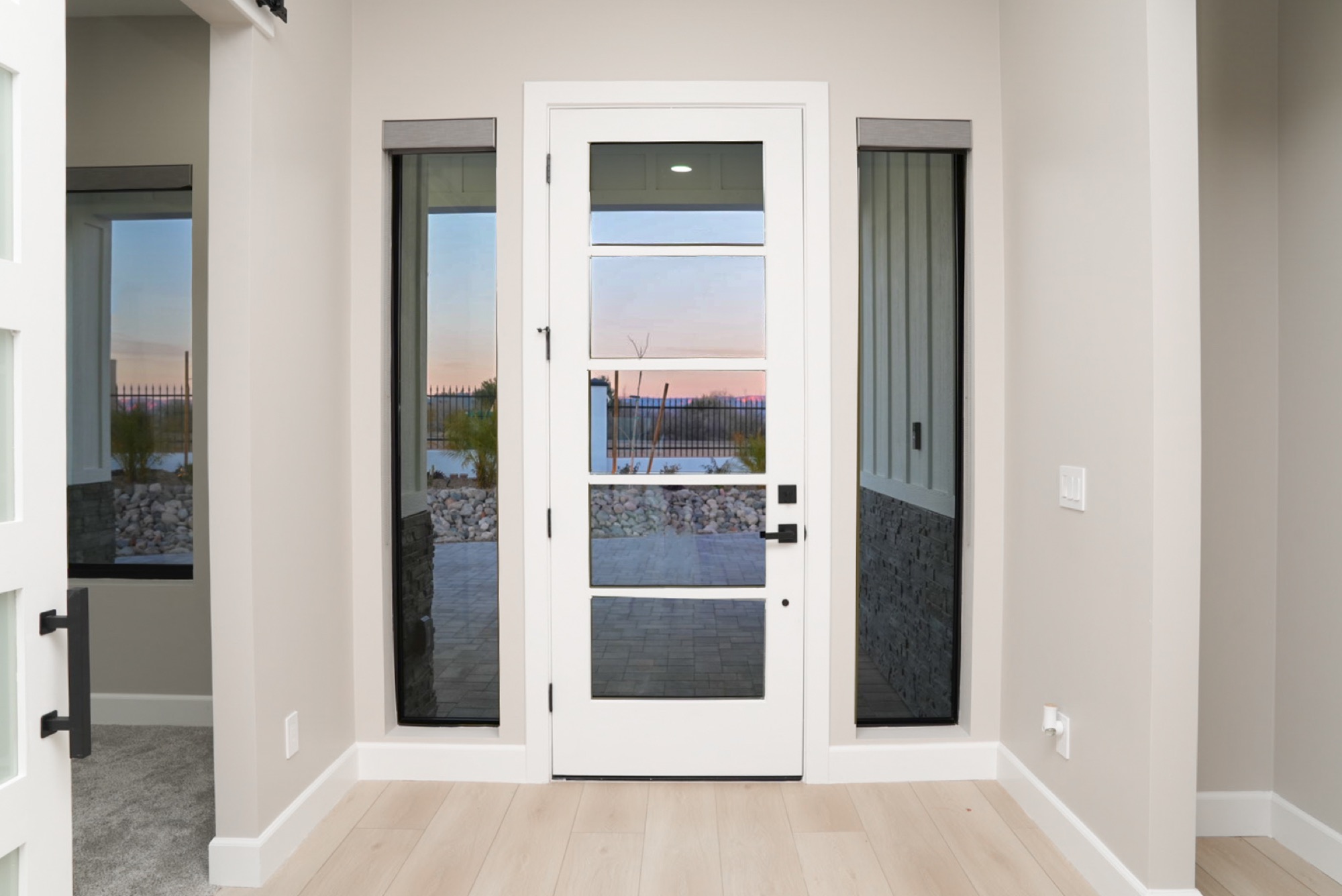 Glass entry door with sunset view straight through the home