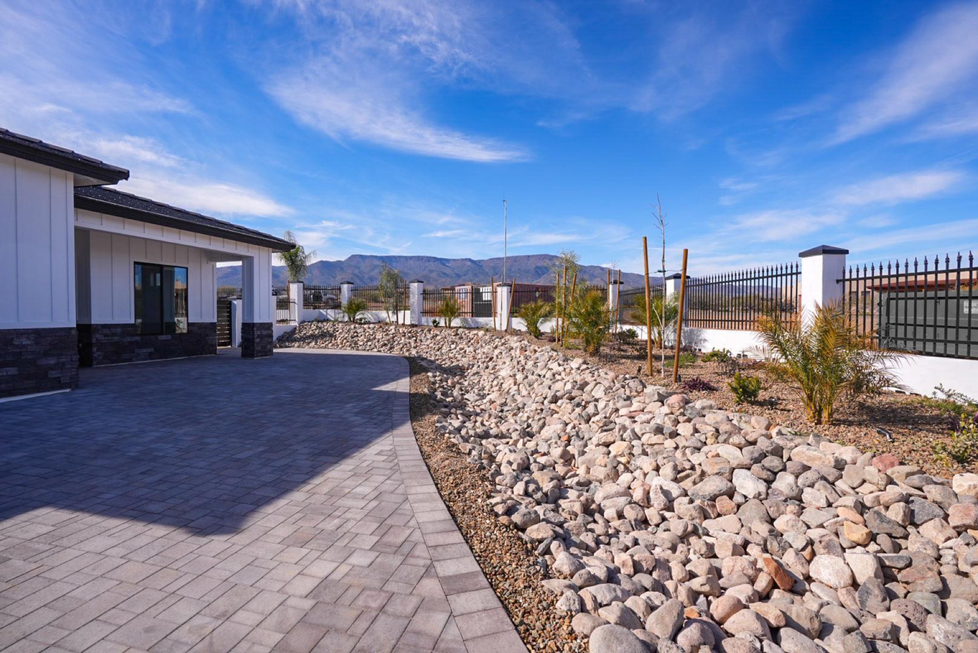 Paver walkway and desert landscaping framing the mountain view