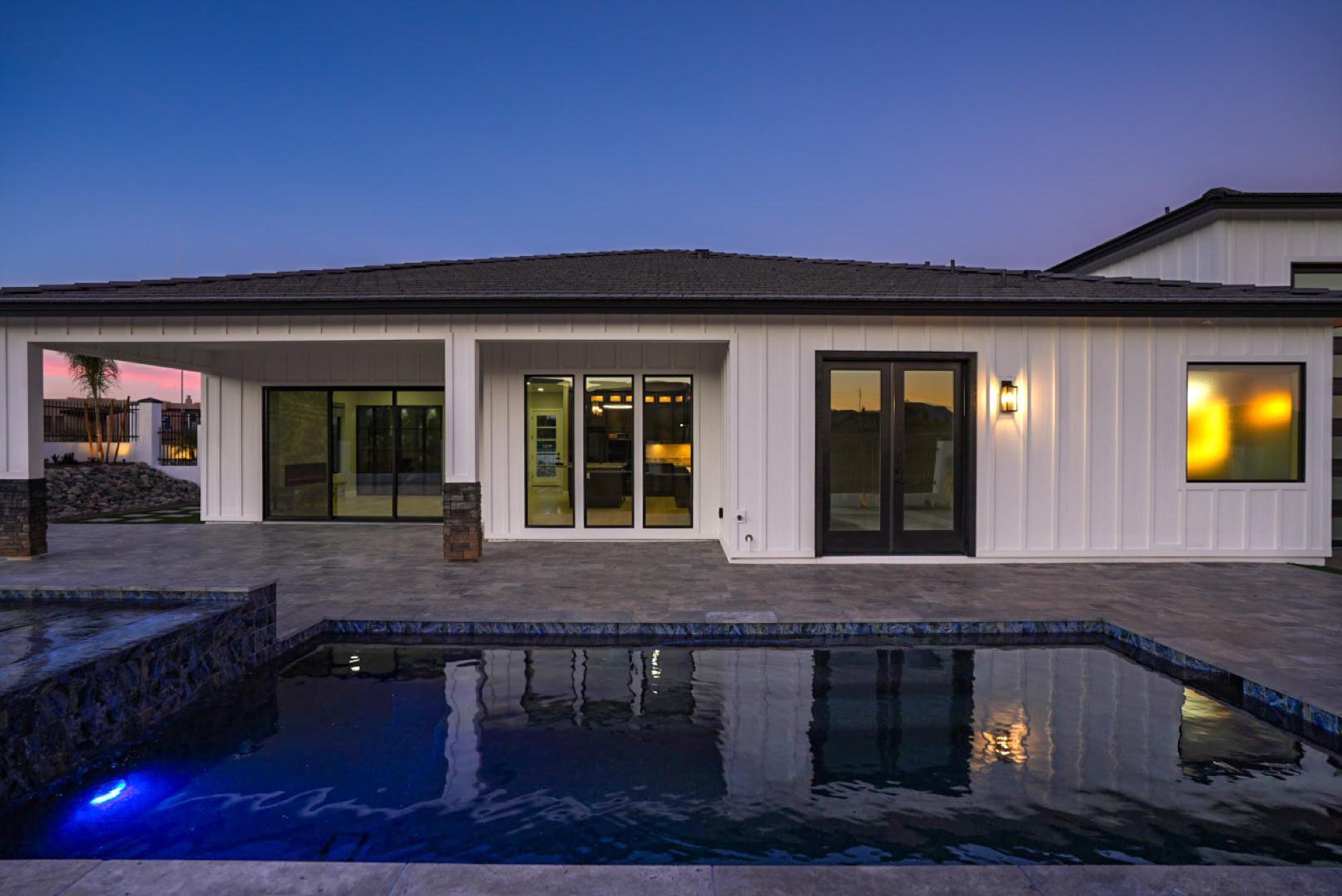 Pool and spa lit at dusk