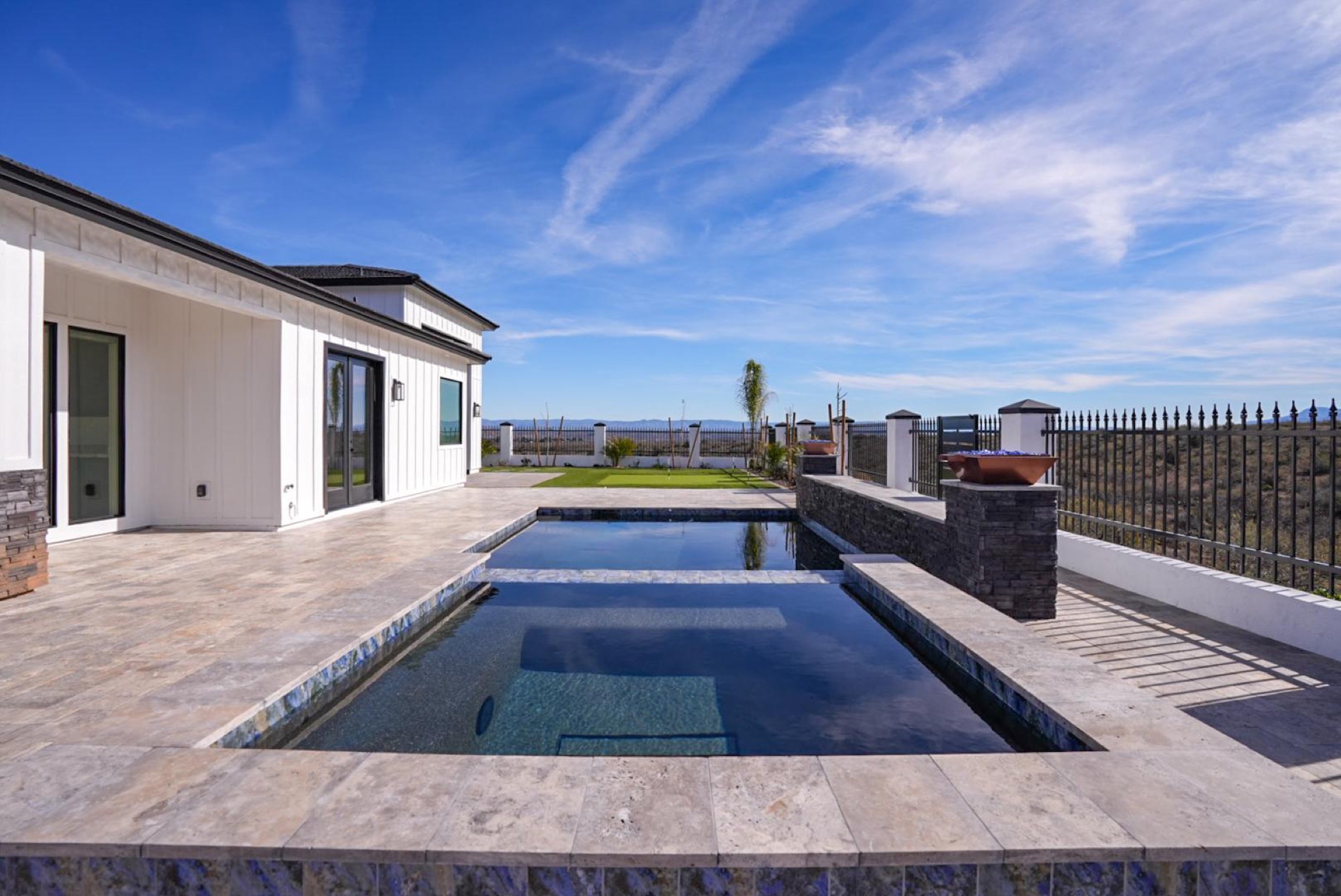 Pool and raised spa in daylight with the valley beyond