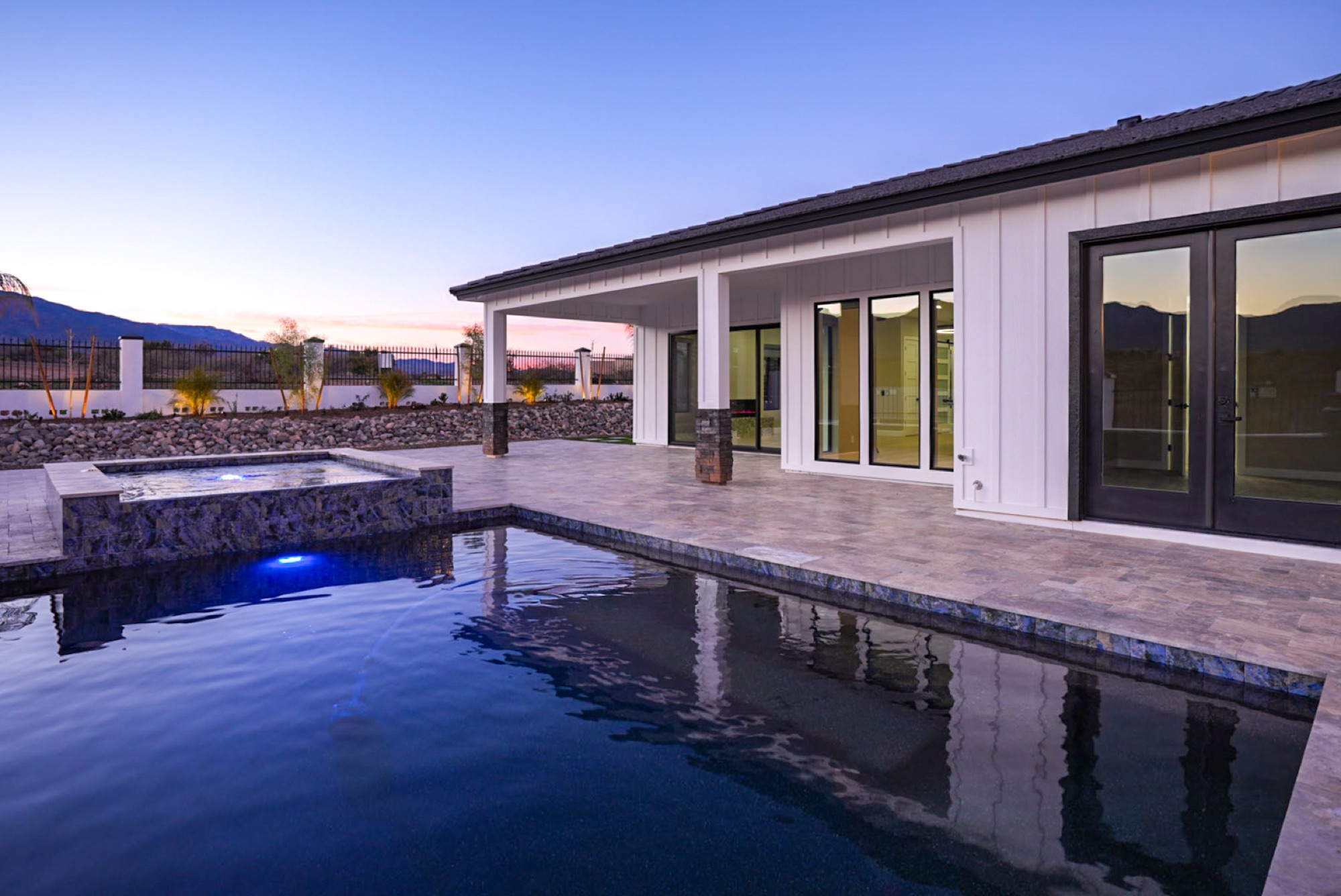 Heated pool and spa lit at twilight