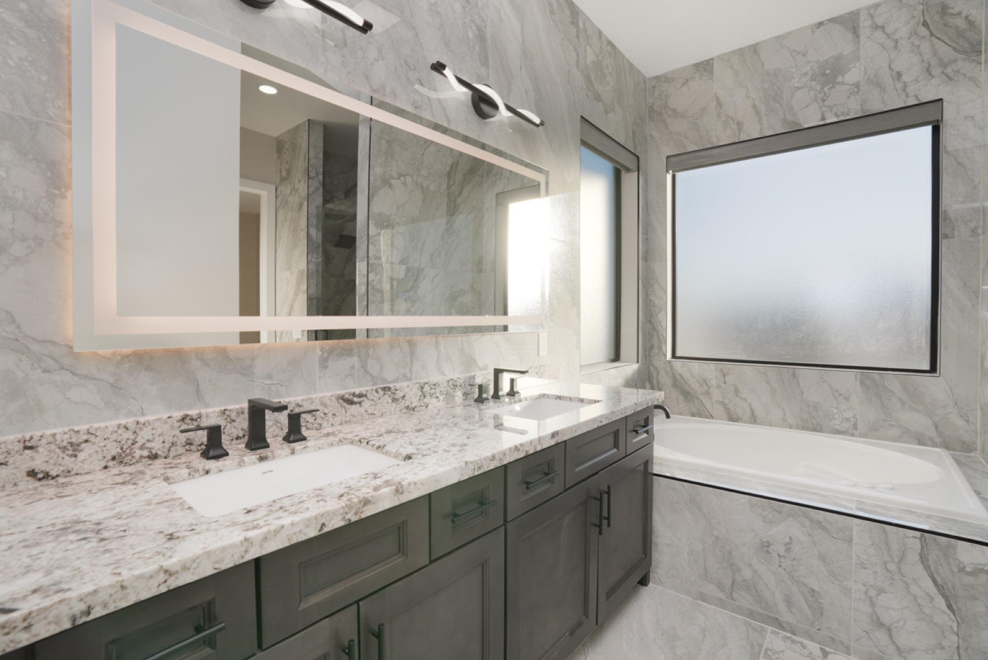 Jetted soaking tub beneath a picture window