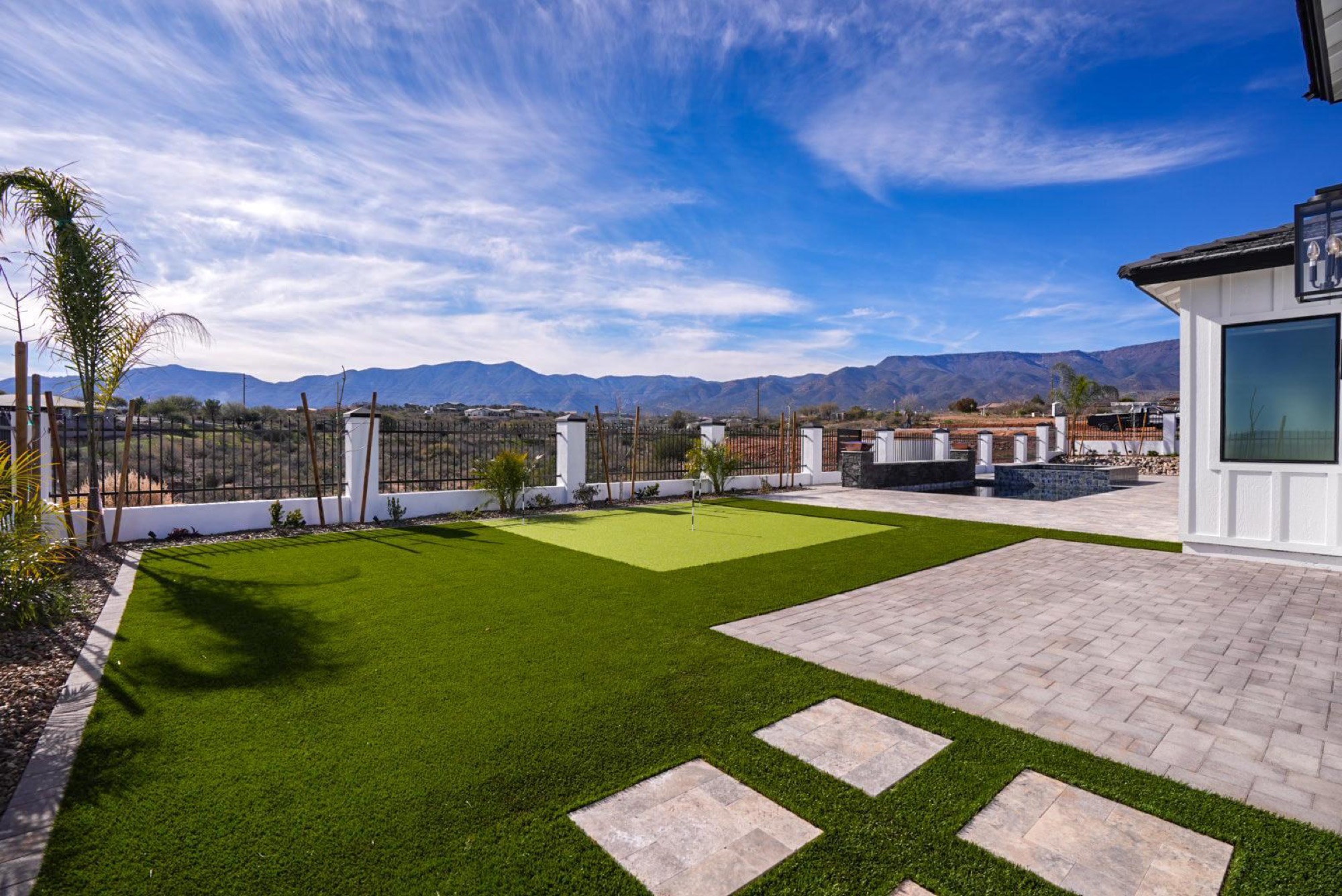 Putting green and turf lawn with the Mingus Mountains beyond