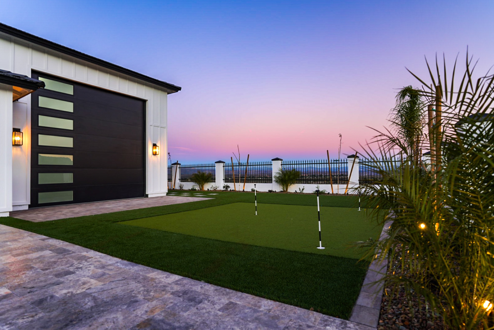 Private putting green at sunset beside the RV garage