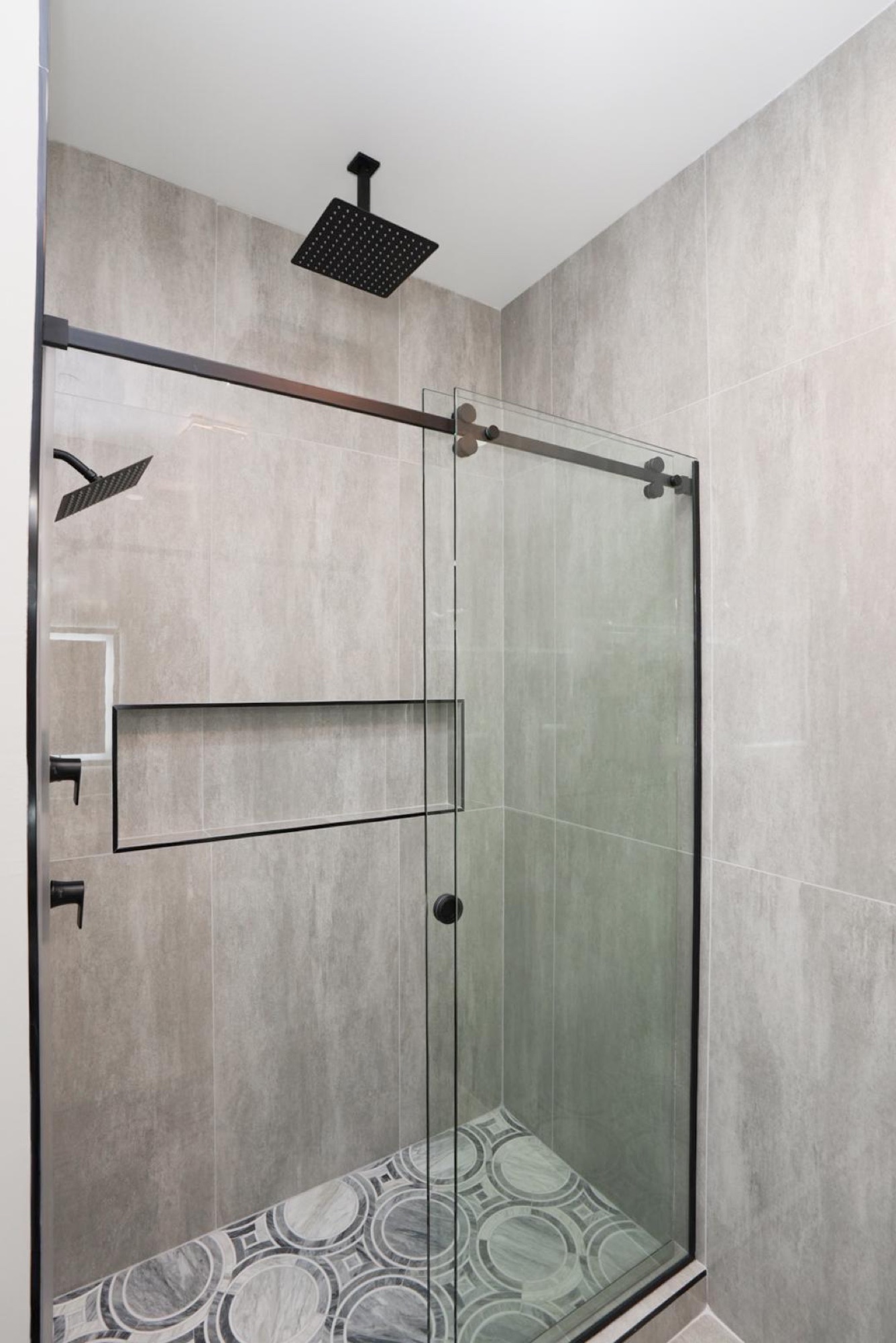 Frameless glass shower enclosure